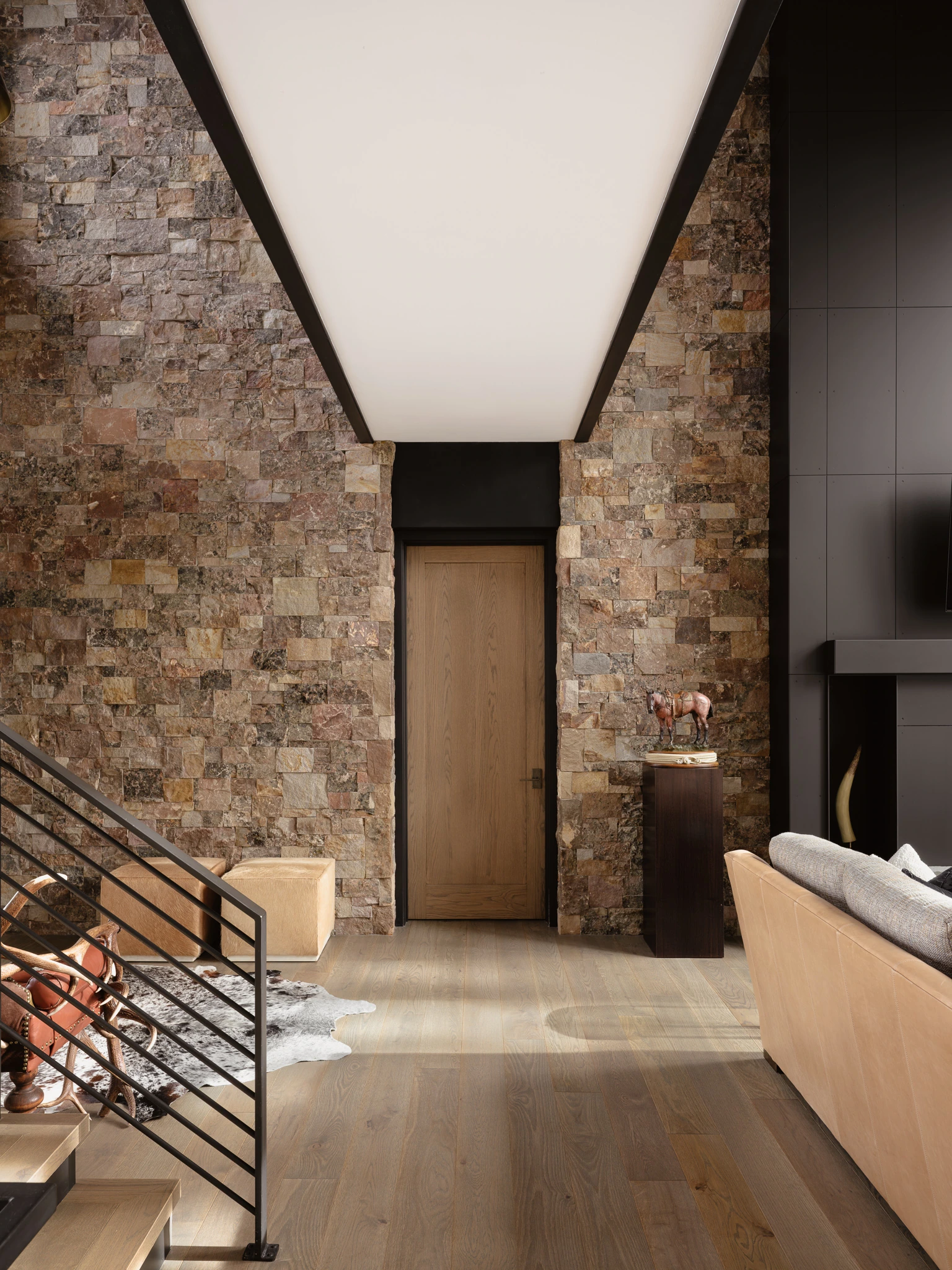 Stacked-stone entry stairwell — architectural photography Big Sky Montana, Speedwell Cabin